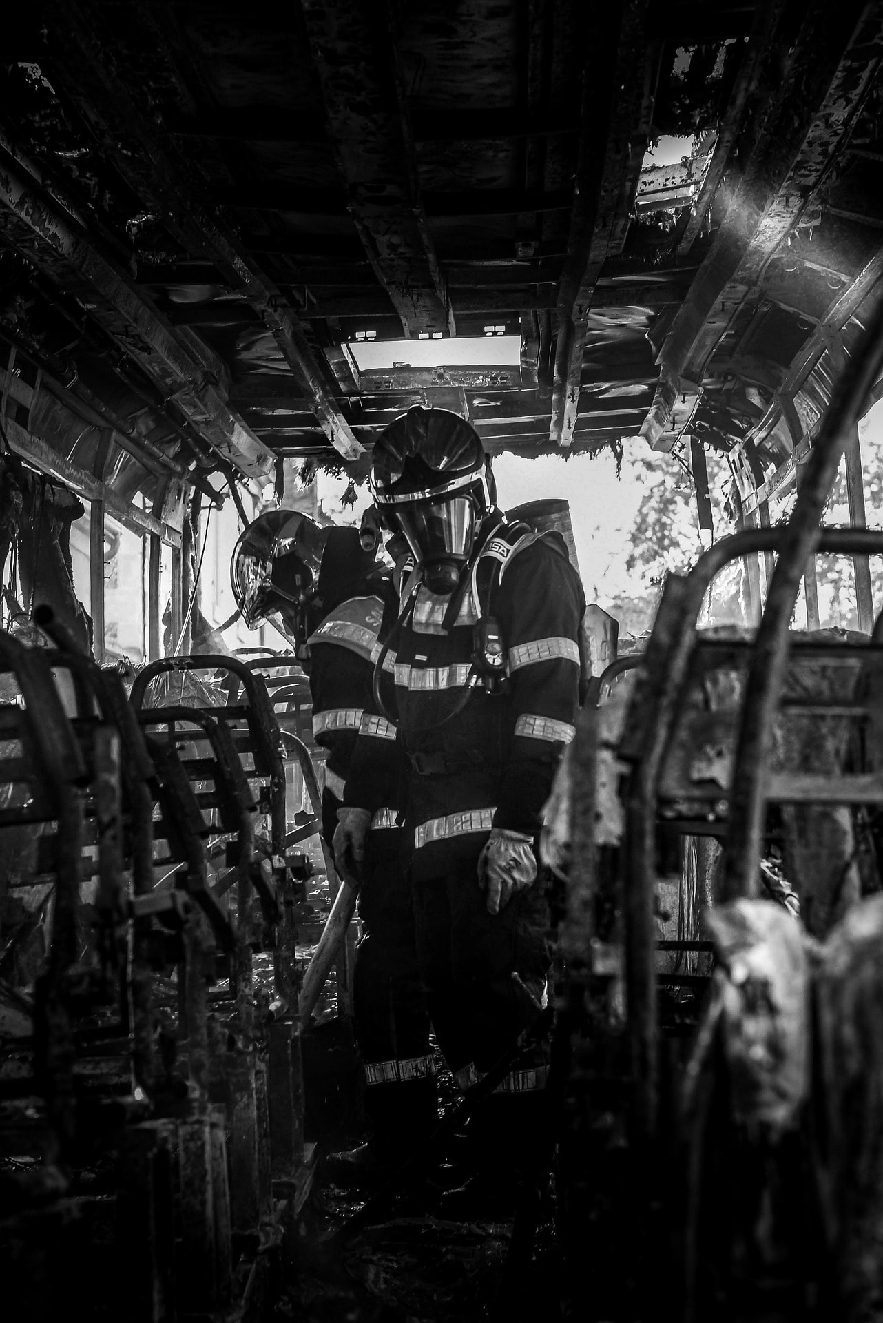 Firefighter in protective gear training inside a damaged structure
