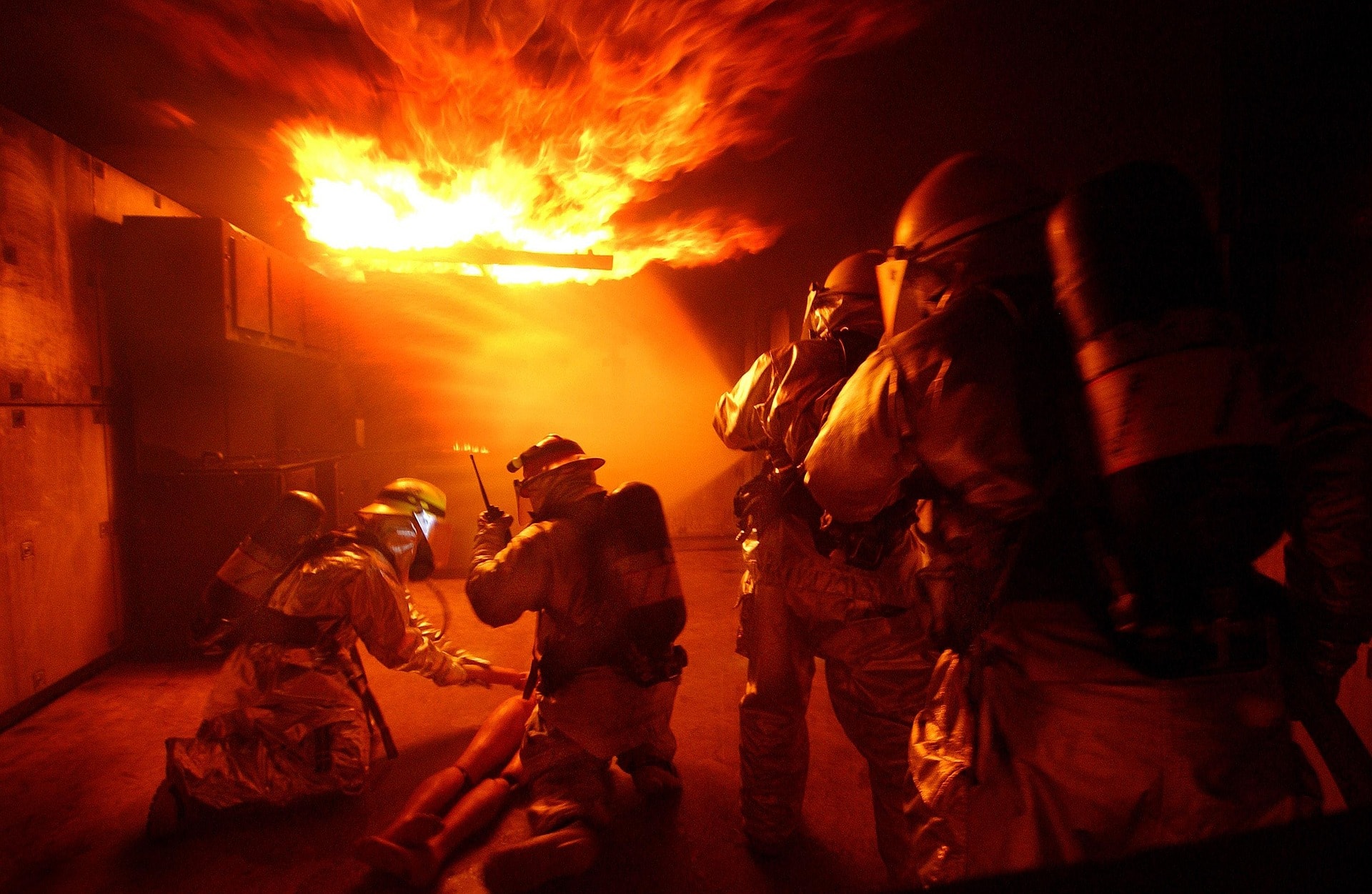 Firefighters responding together during an indoor fire training scenario